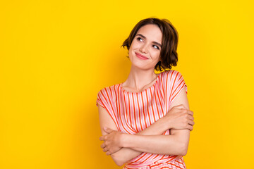 Portrait of attractive minded cheerful brown-haired girl fantasizing copy space isolated over...