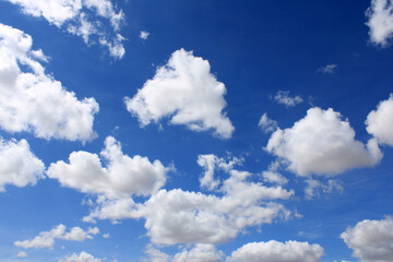Naklejka na ściany i meble Clouds scattered over an intense blue sky