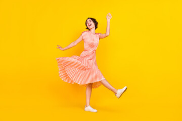 Profile photo of dreamy inspired girl dance look empty space wear striped dress isolated yellow color background