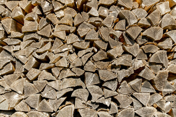 stacked acacia firewood of yellow gray color
