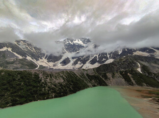 The snow melts in the mountains and drains to the plain. A deep lake in the mountains.