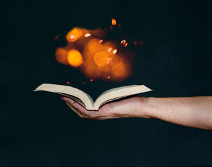 Man holding magic book with hand
