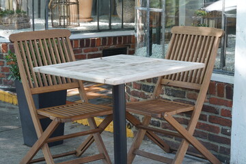 Wooden chairs and marble table in outdoor restaurant
