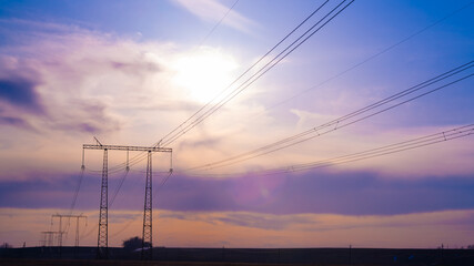 Electric high voltage pole at sunset background - 458245072