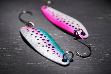 Two fishing lures on a dark table. Preparation for fishing.