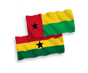 National vector fabric wave flags of Republic of Guinea Bissau and Ghana isolated on white background. 1 to 2 proportion.