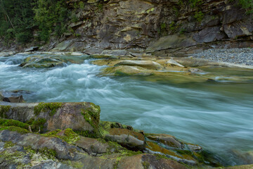 Long exposure rapids of a mountain river with shallow depth of field
