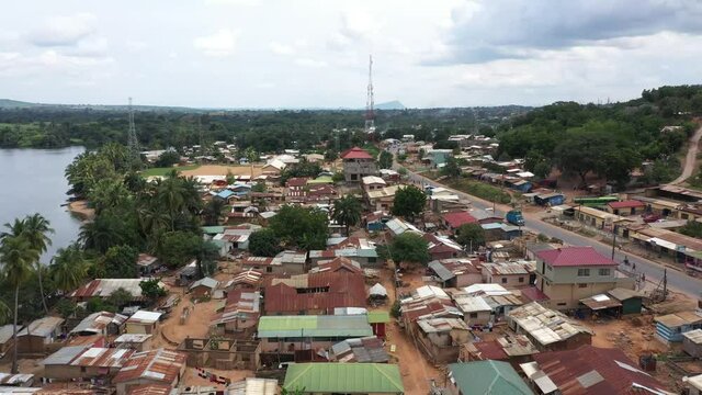 Aerial Adome village buildings Volta river Ghana Africa. Main river system in the West African country of Ghana. The Adome Bridge crosses the river. Eastern Region rural population.