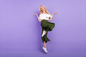 Full length body size photo blonde girl jumping up comparing empty spaces on palms isolated pastel...