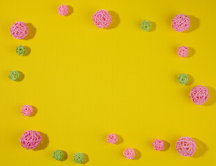 abstract green background with pink and green wicker balls, top view, copy space