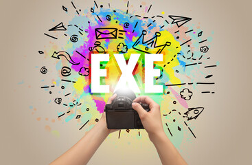 Close-up of a hand holding digital camera with abstract drawing
