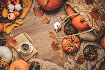 Warm coffee with pumpkins and colorful leaves background top view. Stylish autumn flat lay. Hello fall. Cozy warm image