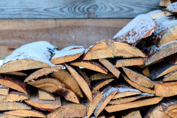 Stacked old boards under the snow.