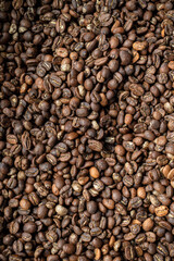 Coffee beans mocha coffee drink macro on brown concrete textured background.
