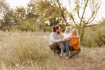 family mom dad daughter on a walk together happy