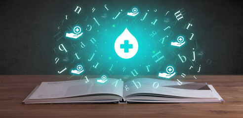 Open medical book with health icons above