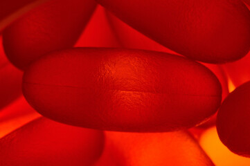 fish oil capsules illuminated from below. close-up.