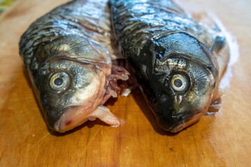 Peeled crucian carp on a cutting board.