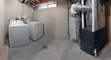 A home laundry room with a dryer, washer, a high efficiency furnace with a residential gas water...