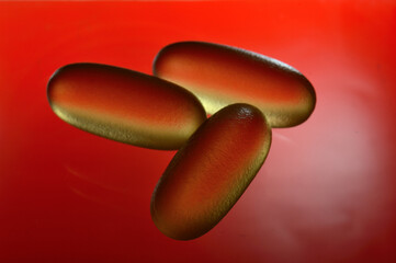 fish oil capsules illuminated from below. close-up.
