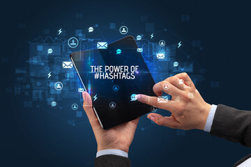 Businessman holding a foldable smartphone, social media concept concept