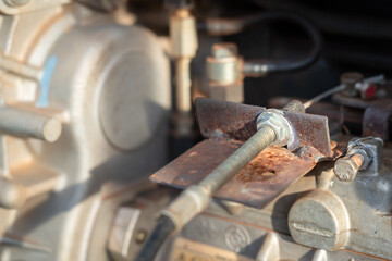 Close-up at metal connection part of hydraulic power pack engine. Industrial equipment object. Selective focus at the bolt-nut part.