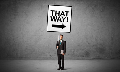 Obraz premium business person holding a traffic sign concept