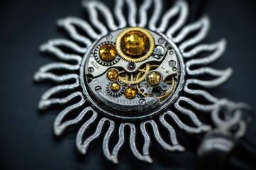 Nice handmade decoration pendant made of metal and watch parts with precious stones of different colors