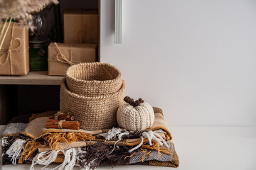 Concept cozy autumn brown colors. Jute basket crocheted, knitted poking, cinnamon, blanket.