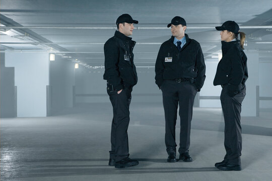 Security Guards Talking In Empty Parking Garage