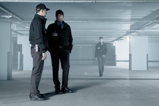 Security Guards Talking In Empty Parking Garage