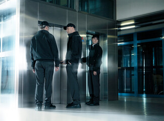 Security guards standing in corridor near elevator