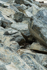 A pile of large stones. Background image of gray granite stone.