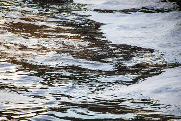 Textured beautiful natural abstract surface for wallpapers and backgrounds. White foam on the water surface