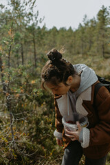 forest picker in the fall with thermos