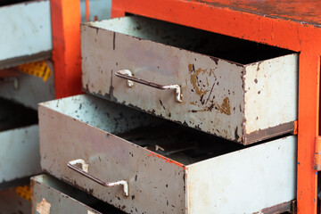Metal drawer shelf box for keep the hand tool equipment in factory storage inventory room. Industrial object photo. Close-up and selective focus at the handle part.