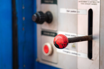 A hand throttle for controlling speed and power of the hydraulic engine in factory, with blurred...