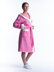 woman in a Bathrobe on an isolated white background with a smile on her face.