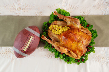 Roasted turkey with football ball. Thanksgiving football concept.