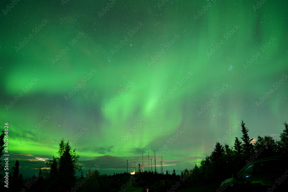 Poster Natural light display of aurora with dynamic patterns of brilliant lights