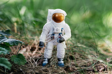 toy astronaut standing on ground. Spaceman figure Travel