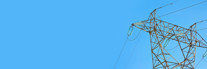 Electricity pylon against a blue sky background  - Web banner design concept with copy space for inserting text