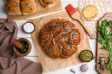 Traditional pampushka rolls with garlic and herbs on white wooden table, flat lay