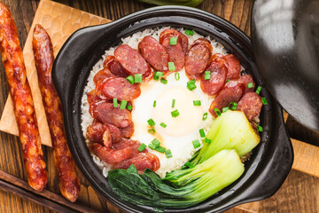 Cantonese style cooking of claypot rice with waxed meats