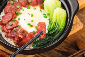 Cantonese style cooking of claypot rice with waxed meats