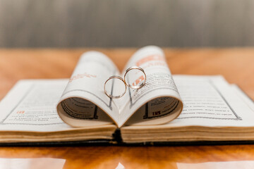 old book with wedding rings