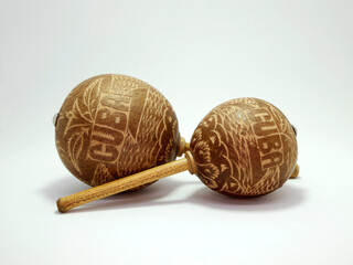 Maracas. Percussion musical instrument. Music. Carved wooden and cane maracas. Rattles Travel memories. Souvenirs from Cuba. Isolated white.
