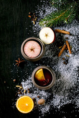 Hot mulled wine with spices and Christmas decorations