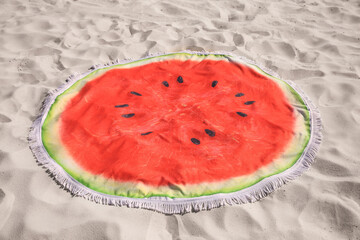 Beautiful watermelon beach towel with tassels on sand