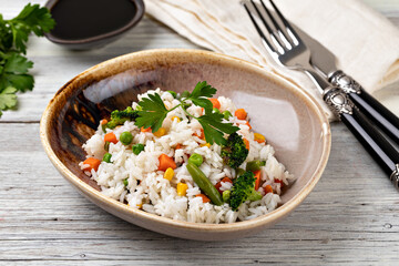 Bowl with tasty rice and vegetables